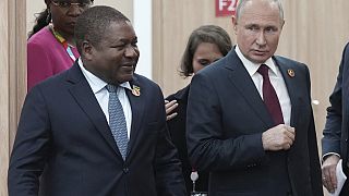 Russian President Vladimir Putin, right, and Mozambique President Filipe Nyusi arrive for a meeting on the sidelines of the Russia-Africa Summit