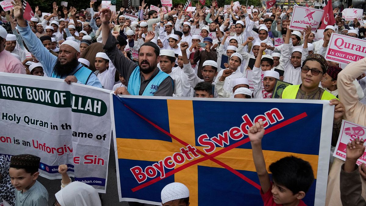 Protesters in Lahore, Pakistan hold copies of the Quran as they chant slogans to denounce a burning of the holy book that took place in Sweden