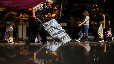 A man pushes a trolley with bottles of water on a hot summer day, in Istanbul, Turkey, July 13, 2023.