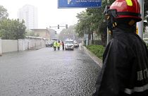 Firefighter surveills a cordonened off area under heavy rainfall during Typhoon Doksuri 