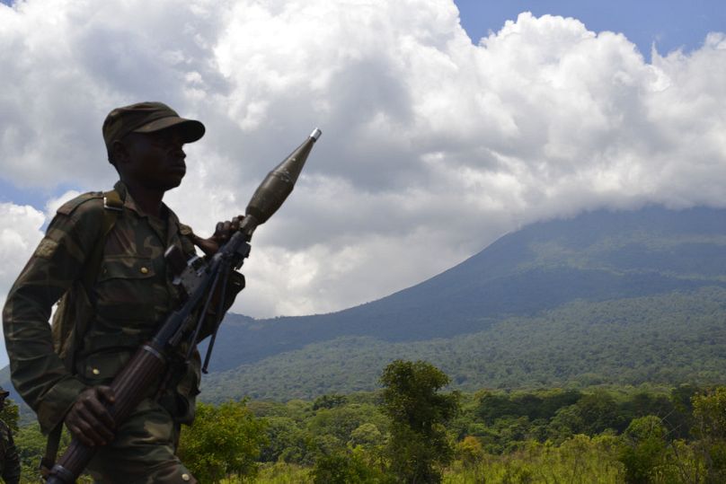 FILE - In this Friday, Oct. 25, 2013 file photo, a Congolese army soldier walks near the frontline during fighting with M23 rebels north of Goma, eastern Congo. 