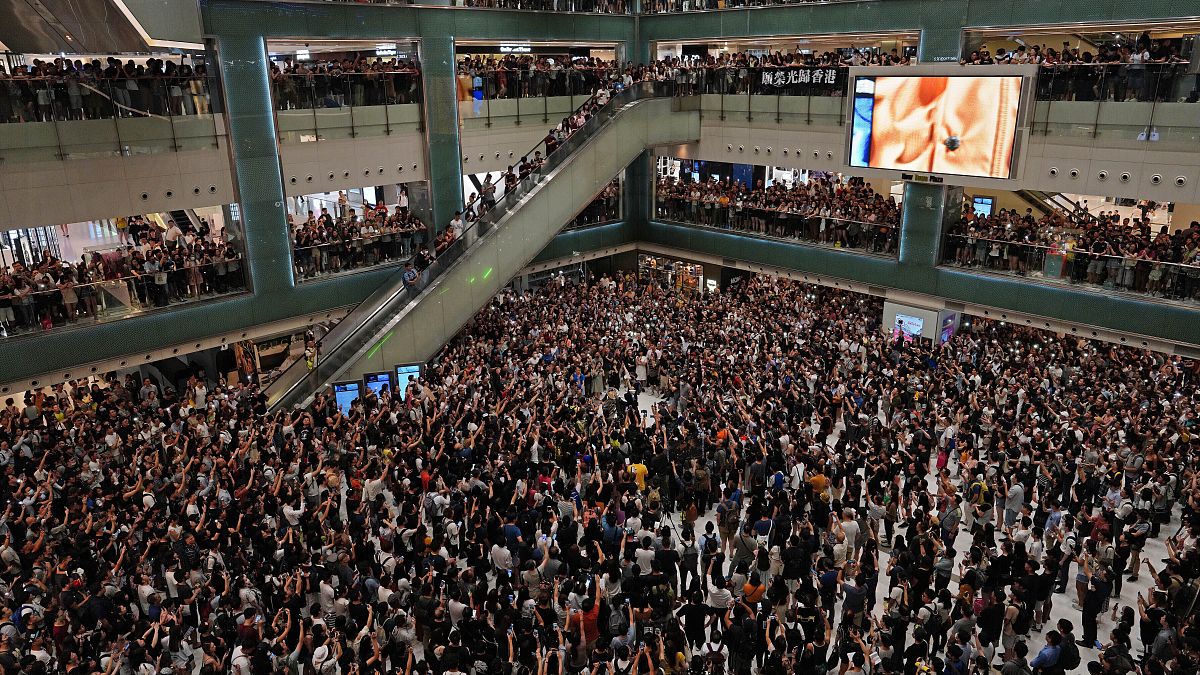 Local residents sing a theme song written by protesters "Glory be to thee" at a shopping mall in Hong Kong on Sept. 11, 2019.