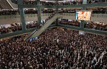 Local residents sing a theme song written by protesters "Glory be to thee" at a shopping mall in Hong Kong on Sept. 11, 2019.