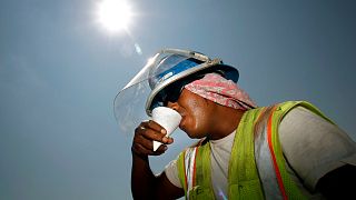 Construction worker Miguel Gomez takes a break from the heat while working on a shopping centre.