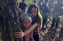 88-year-old Zehra Yıldırım hugging a tree to protect it from being felled on 26 July. She is shielded by activist leader Esra Işık.