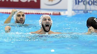 Greece's Konstantinos Genidounias celebrates after scoring a goal against Hungary during their men's water polo gold medal match at the World Swimming Championships in Fukuoka