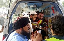 In this photo provided by Rescue 1122 Head Quarters, rescue workers carry a wounded man after an explosion in the Bajur district of Khyber Pakhtunkhwa, Pakistan, July 30, 2023