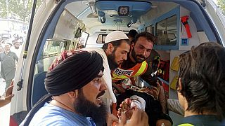 In this photo provided by Rescue 1122 Head Quarters, rescue workers carry a wounded man after an explosion in the Bajur district of Khyber Pakhtunkhwa, Pakistan, July 30, 2023