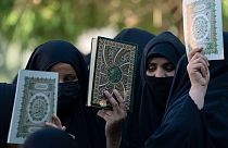 Iraqis raise copies of the Quran, Muslims' holy book, during a protest in Baghdad, Iraq, Saturday, July 22, 2023