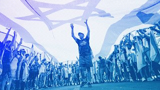 Demonstrators wave large Israeli flag during a protest against plans by PM Benjamin Netanyahu to overhaul the judicial system, outside the Knesset in Jerusalem, July 2023
