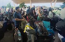 French and other nationals gather at the international Airport to be airlifted back to France on a French military aircraft, in Niamey, Niger, Wednesday, Aug. 2, 2023.