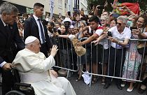 Pope Francis waves to the crowd as he arrives for a meeting with the Portugal's Prime Minister Antonio Costa in Lisbon, Wednesday, Aug. 2, 2023.