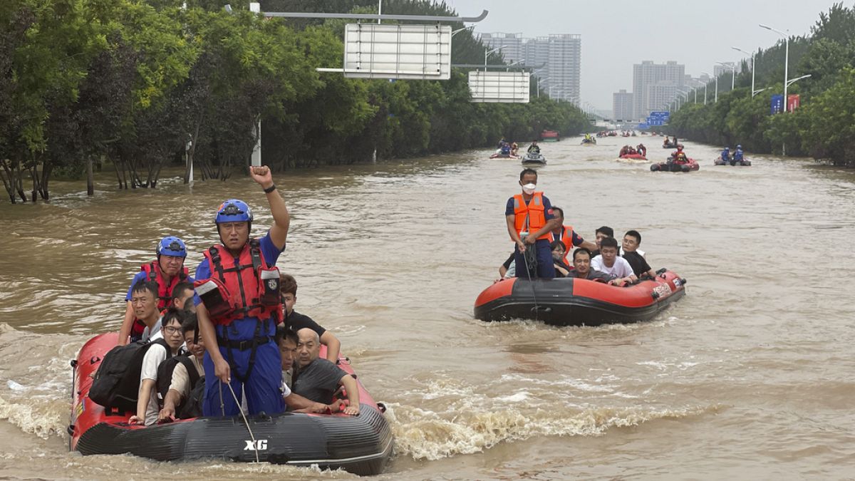 Residents are evacuated by rubber boats through flood waters in Zhuozhou in northern China's Hebei province, south of Beijing, Wednesday, Aug. 2, 2023. 