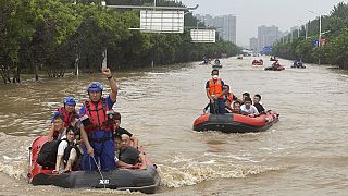 Residents are evacuated by rubber boats through flood waters in Zhuozhou in northern China's Hebei province, south of Beijing, Wednesday, Aug. 2, 2023.