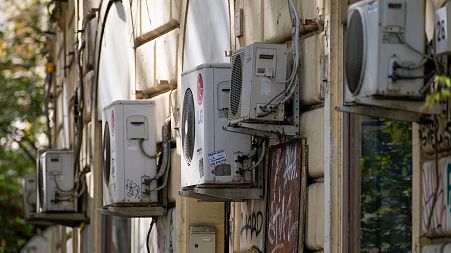 Air conditioning external units are seen on the wall of a building in Rome.
