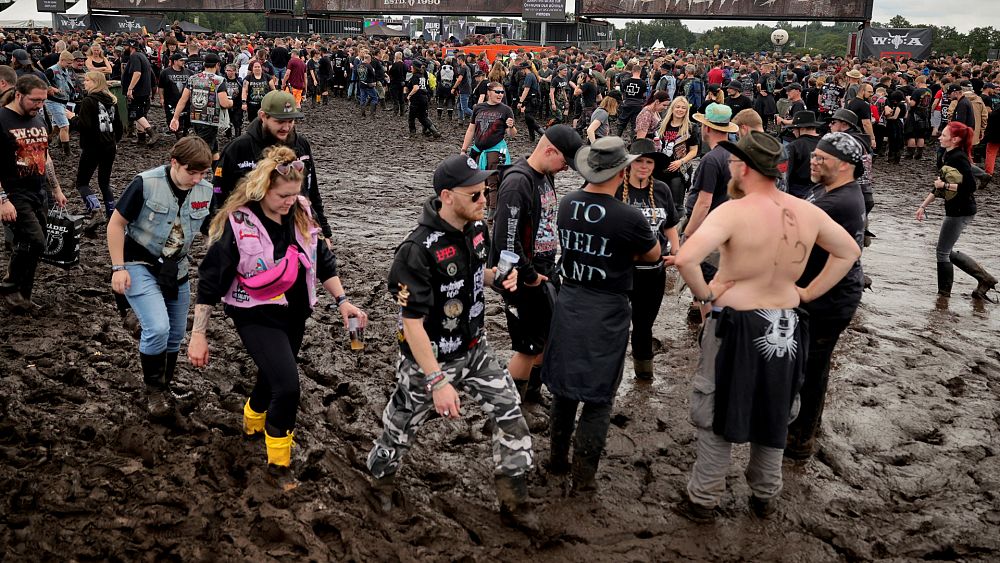 A fan walks in the stands as rain canceled the start of the