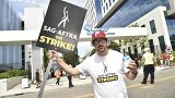 Adam Shapiro poses on a picket line outside Netflix studios on Tuesday, Aug. 1, 2023, in Los Angeles. 