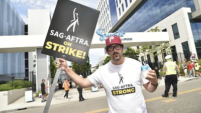 Adam Shapiro poses on a picket line outside Netflix studios on Tuesday, Aug. 1, 2023, in Los Angeles. 