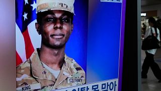 A TV screen shows a file image of American soldier Travis King during a news program at the Seoul Railway Station in Seoul, South Korea, Monday, July 24, 2023.