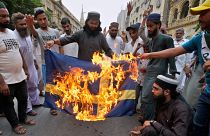 Hardline Islamist protesters burn the Swedish flag in Karachi, Pakistan