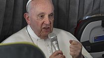 Pope Francis meets the journalists during a press conference aboard the aeroplane directed to Rome, at the end of the 37th World Youth Day in Lisbon, Sunday, Aug. 6, 2023. 