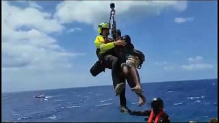Coastguard rescue migrants from rocks