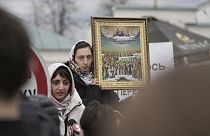 A supporter of Ukrainian Orthodox Church holds an icon outside the Kyiv Pechersk Lavra monastery complex in Kyiv, Ukraine, Saturday, April 1, 2023.