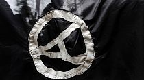 FILE - Anarchist supporters are seen through an anarchist flag during a rally marking the International May Day on May 1, 2009. 