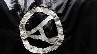 FILE - Anarchist supporters are seen through an anarchist flag during a rally marking the International May Day on May 1, 2009.