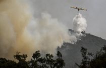 A Canadair amphibious aircraft drops water over a wildfire in Reguengo, Portalegre district, south of Portugal, on August 8, 2023. 