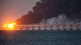 FILE - Flame and smoke rise fron Crimean Bridge connecting Russian mainland and Crimean peninsula over the Kerch Strait, in Kerch, Crimea, Saturday, Oct. 8, 2022.