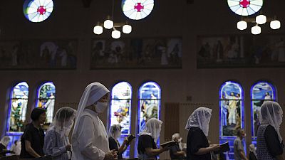 People attend an early morning Mass at the Urakami Cathedral on the 78th anniversary of the atomic bombing in Nagasaki, southern Japan, Wednesday, August 9, 2023. 