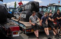Protesting farmers talk at a blockade outside a distribution centre for supermarket chain Aldi in the town of Drachten, northern Netherlands, on 4 July 2022.