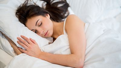 FILE: Woman sleeping soundly in her bed