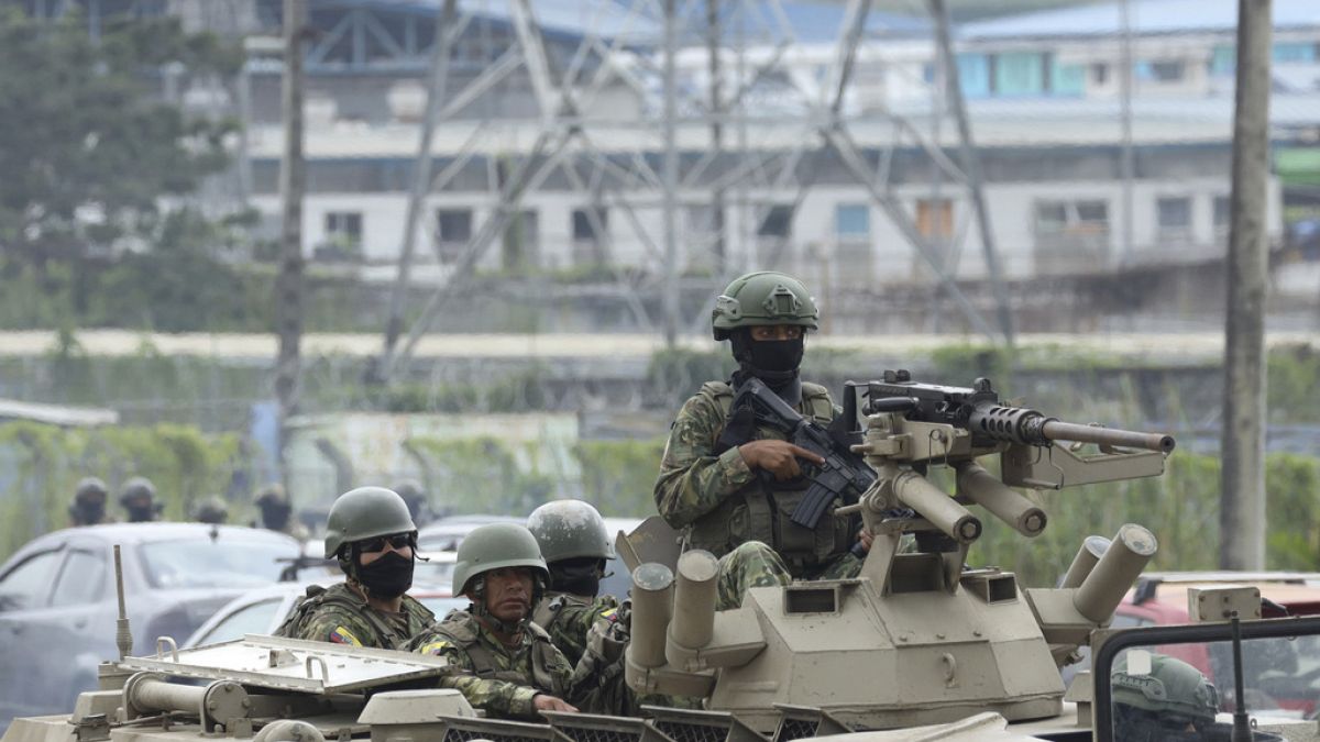 Armored vehicles enter the Deprivation of Liberty Center of the Zone 8 in Guayaquil, Ecuador, Saturday, Aug. 12, 2023.