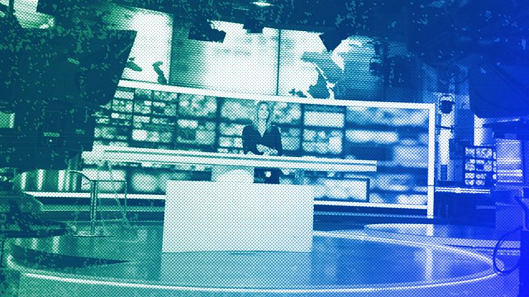 Dagmara Kaczmarek-Szałkow, a news presenter for TVN24, speaks during a live news broadcast in Warsaw, December 2021