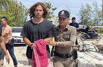 A Thai police officer escorts Spanish Daniel Sancho Bronchalo on suspicion of murdering and dismembering a Colombian surgeon from Koh Phagnan island to Koh Samui Island court.