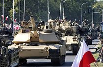 U.S.-made Abrams tanks purchased by Poland take part in a massive military parade to celebrate the Polish Army Day.