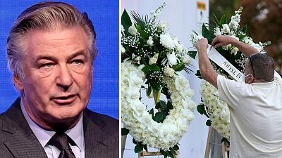 Alec Baldwin (left) - right: A man puts up a wreath before a candlelight vigil for the late cinematographer Halyna Hutchins in 2021
