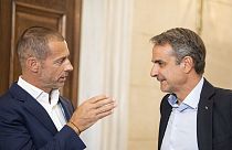 Greek Prime Minister Kyriakos Mitsotakis, right, speaks with UEFA President Aleksander Ceferin after their meeting in Athens, Wednesday, Aug. 16, 2023