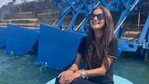 Inna Braverman sits infront of the Eco Wave Power station installed in Israel.