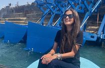 Inna Braverman sits infront of the Eco Wave Power station installed in Israel. 