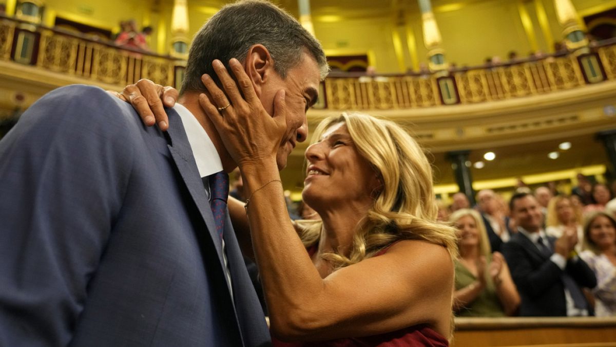 Acting Prime Minister Pedro Sánchez is embraced by Yolanda Diaz before the start of a voting session at the Spanish parliament in Madrid, Spain, Thursday, Aug. 17, 2023.