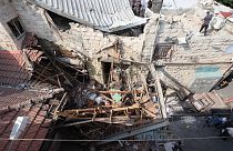 فلسطينيون يتفقدون الأضرار التي لحقت بمنزل في جنين بالضفة الغربية المحتلة في 17 أغسطس 2023، في أعقاب غارة عسكرية إسرائيلية.