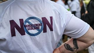 A tee-shirt with "No to school bullying" is worn during a commemorative march in memory of 13-year-old Lindsay who committed suicide following school harassment in France.