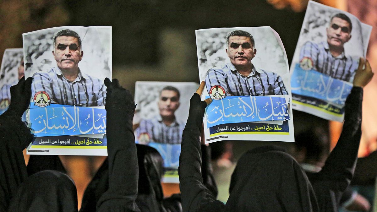 متظاهرون بحرينيون مناهضون للحكومة يرفعون صورًا لناشط حقوق الإنسان المسجون نبيل رجب خلال احتجاج تضامني في البحرين