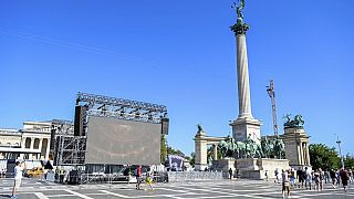 The start and finish area of six races of the World Athletic Championships is prepared as tourists look around in the Heroes' Square in Budapest.