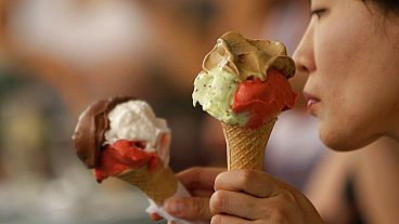 FILE: Customers enjoy cones outside the Giolitti gelateria in Rome in 2010.