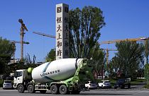A cement truck moves past a new Evergrande housing development in Beijing on Sept. 22, 2021.