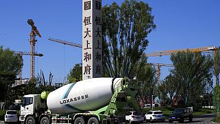 A cement truck moves past a new Evergrande housing development in Beijing on Sept. 22, 2021.